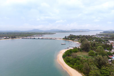 High angle view of city by sea against sky