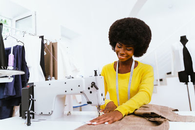 Close-up of fashion designer working at studio