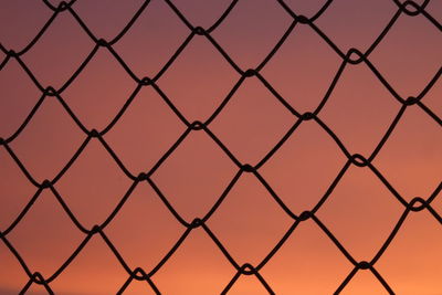 Full frame shot of chainlink fence against sky