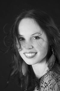 Close-up portrait of smiling young woman