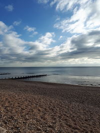 View of beach against cloudy sky