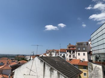 Buildings in city against blue sky