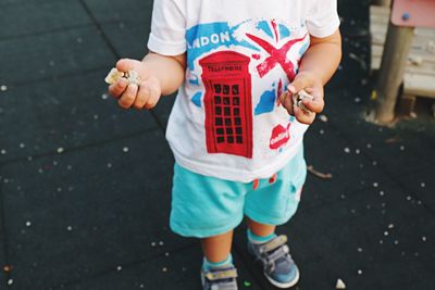 Low section of boy standing on street