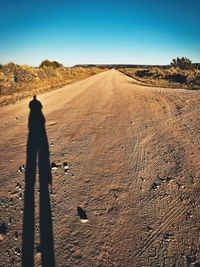 Shadow of man on sand