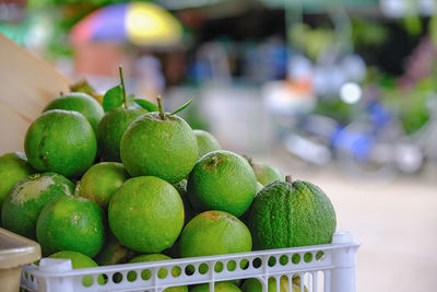 Close-up of fruits in basket at market stall