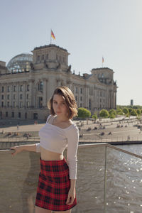 Woman standing in front of historical building