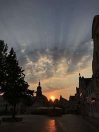 Buildings against sky during sunset in city