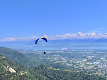 People flying kite against sky