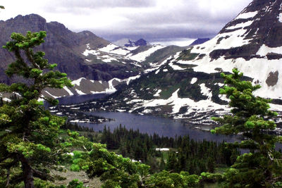 Scenic view of lake by mountains against sky