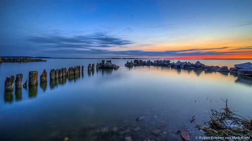 Reflection of clouds in sea at sunset