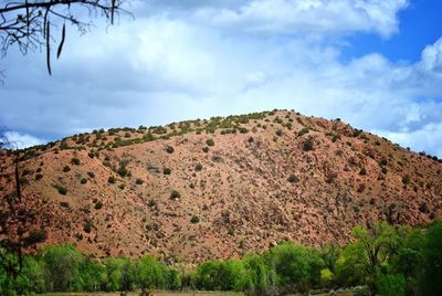 Scenic view of mountains against cloudy sky