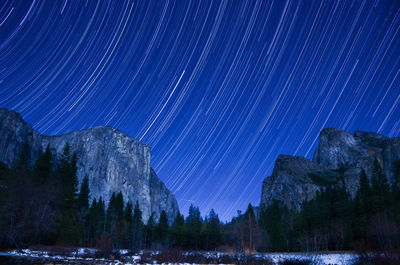 Scenic view of mountains against sky at night