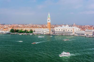 Ferries sailing in grand canal by church of san giorgio maggiore against sky