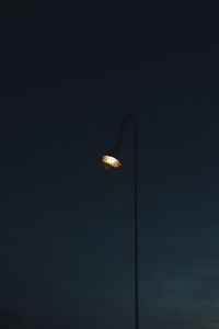 Low angle view of illuminated street light against sky at night