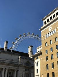 Low angle view of buildings against blue sky