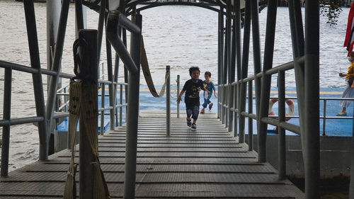 Rear view of people walking on staircase