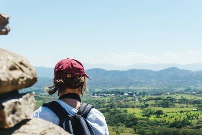 Rear view of woman against mountain range