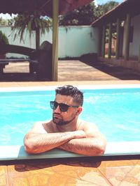 Man wearing sunglasses in swimming pool