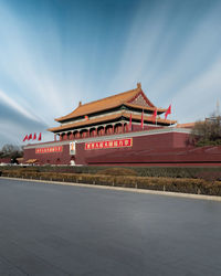 View of temple building against cloudy sky