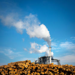 Smoke emitting from chimney against blue sky