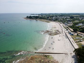 High angle view of sea and city against sky