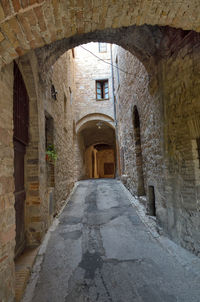 Narrow walkway leading towards historic building