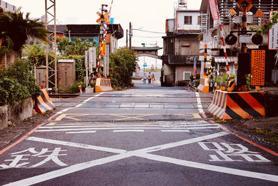 Road sign on street amidst buildings in city