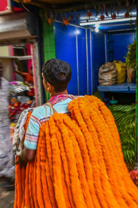 Rear view of man standing at market stall