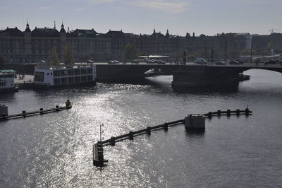 Bridge over river against sky in city