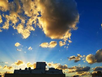 Low angle view of silhouette buildings against sky