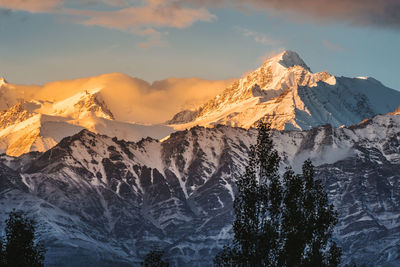 Scenic view of snowcapped mountains against sky during sunset