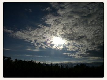 Scenic view of landscape against cloudy sky