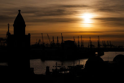 Silhouette boats in sea against sunset sky