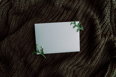 Directly above shot of envelope on sweater