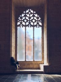 Man seen through window