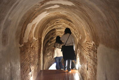 Rear view of man standing in tunnel