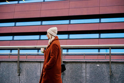 Woman at city street with coffee cup