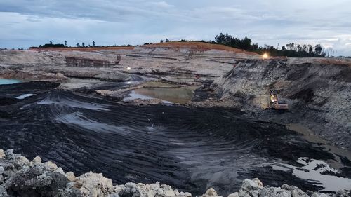 A landscape image of a coal mining operation area, the liquid mud unites with the coal parting.