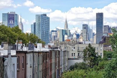 Buildings in city against sky