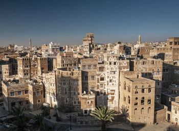 High angle view of buildings against clear blue sky