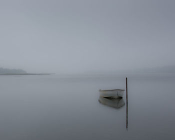 Scenic misty view of lake against sky