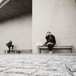 Full length of woman standing by railing