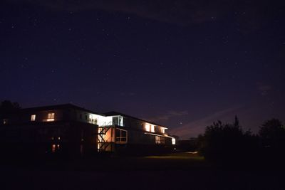 Illuminated buildings against sky at night