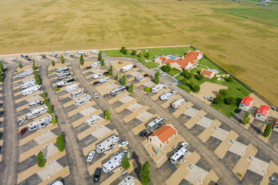 High angle view of houses on field by buildings