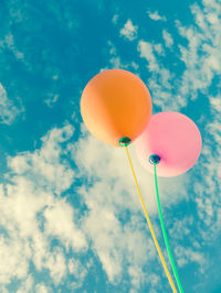 Low angle view of balloons against sky