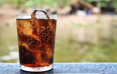 Close-up of cola in glass on table