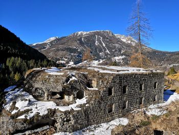 Scenic view of snowcapped mountains against clear blue sky