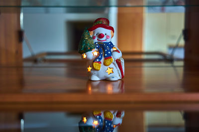 Close-up of snowman figurine on table at home