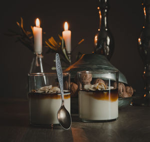 Close-up of illuminated candles on table