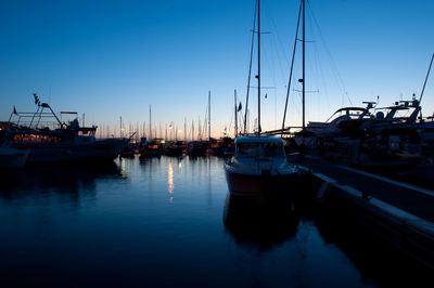 Boats moored at harbor